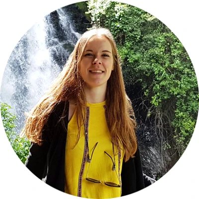 intern Angela in front of a waterfall