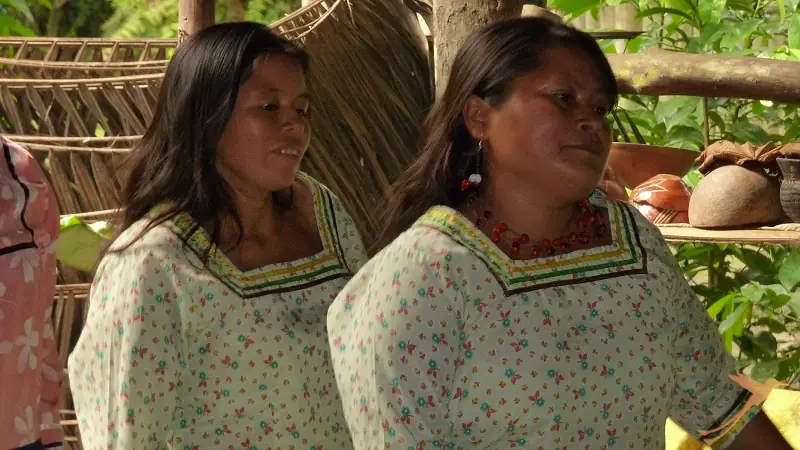 two indigenous women with traditional cloths in the rainforest