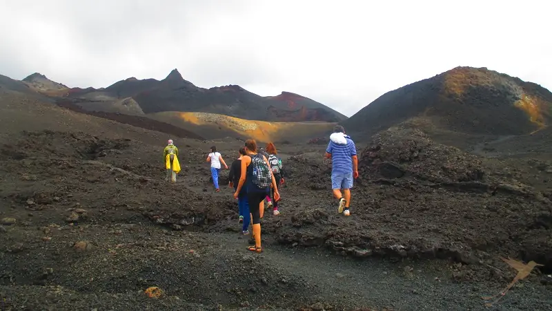 people hiking Sierra Negra volcano on Isabela Island