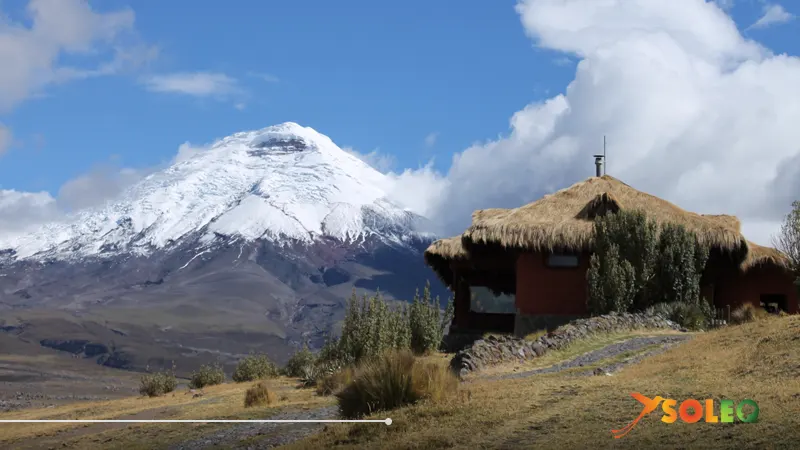 Thatched eco-lodge with view of snow-covered Cotopaxi volcano in Ecuador