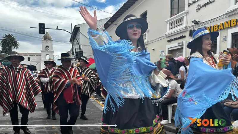 Traditional dancers in colorful outfits during the Mama Negra festival in Latacunga, Ecuador.