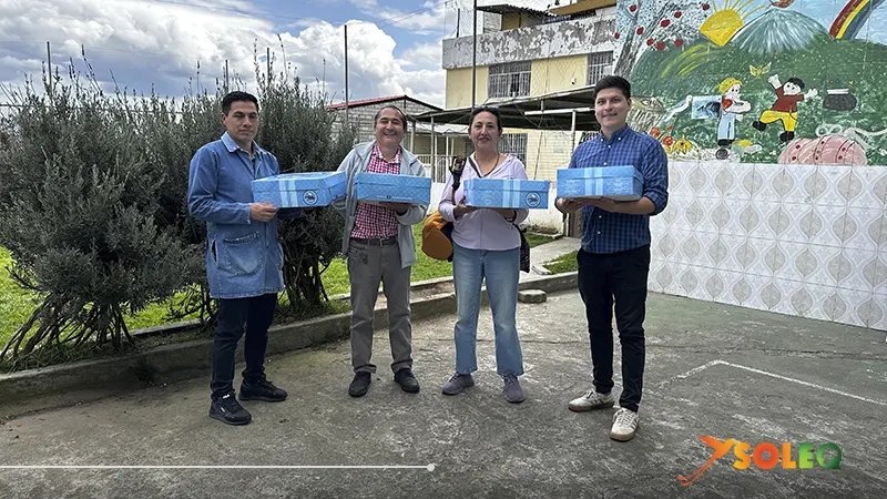 Miembros del equipo entregando suministros donados al proyecto social Refugio de los Sueños en Quito, Ecuador.