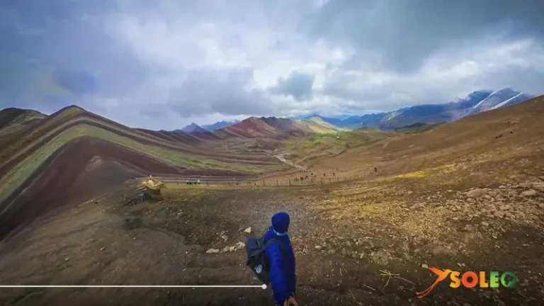View over the landscape of Rainbow Mountain Peru (Vinicunca) – Hikers descending through the colorful mountains of the Peruvian Andes.