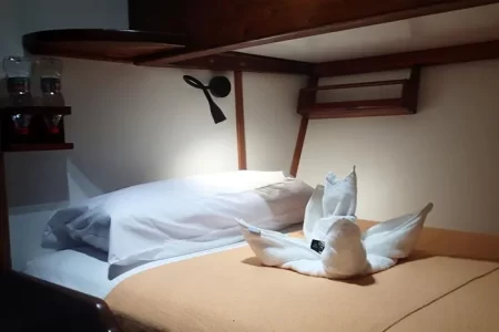 double bed in a cabin of Samba Galapagos